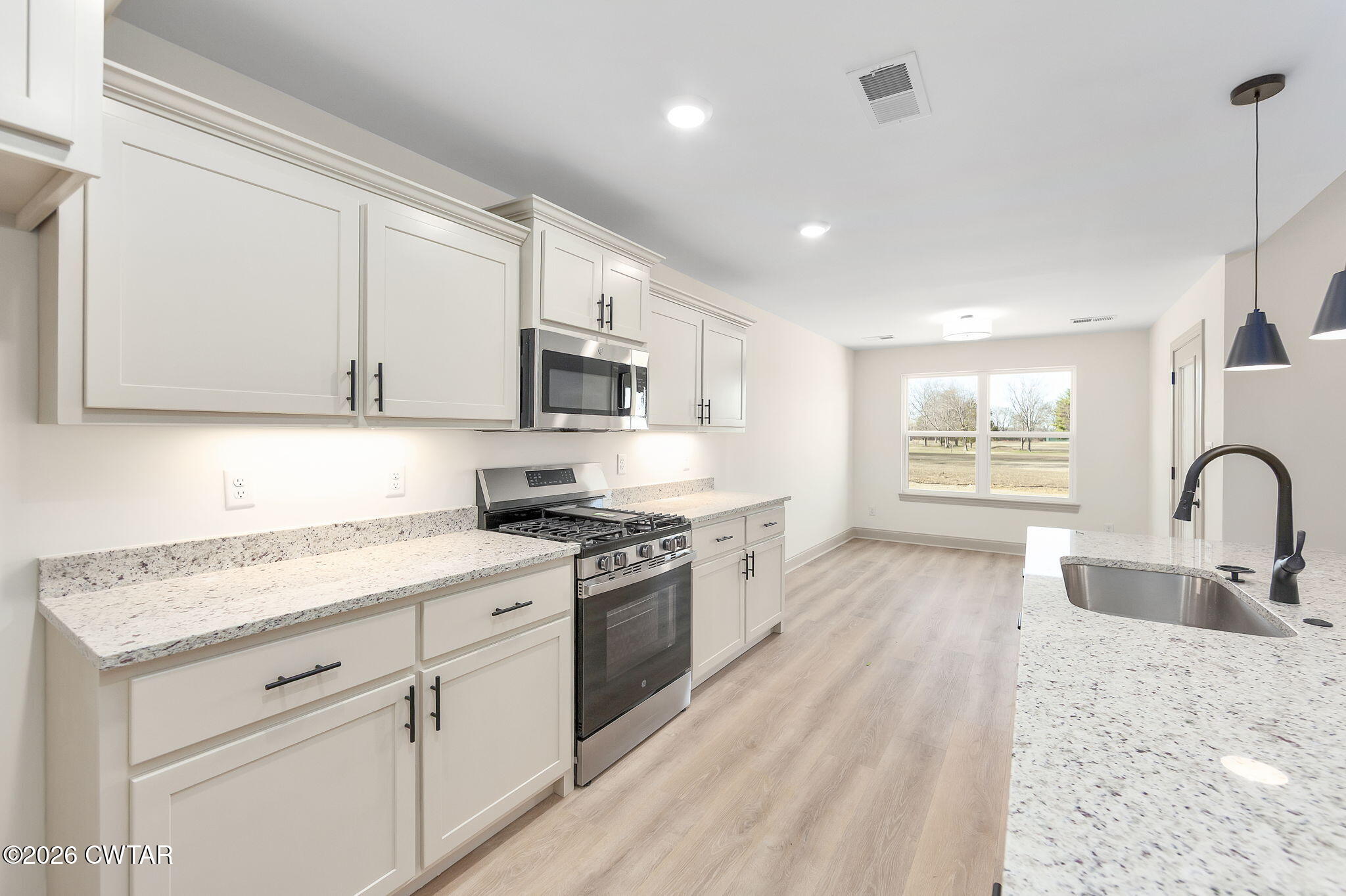 77 Grande Pnes Cove Jackson, TN 38305 - Photo 7 of 31 a kitchen with white cabinets appliances a sink and a window