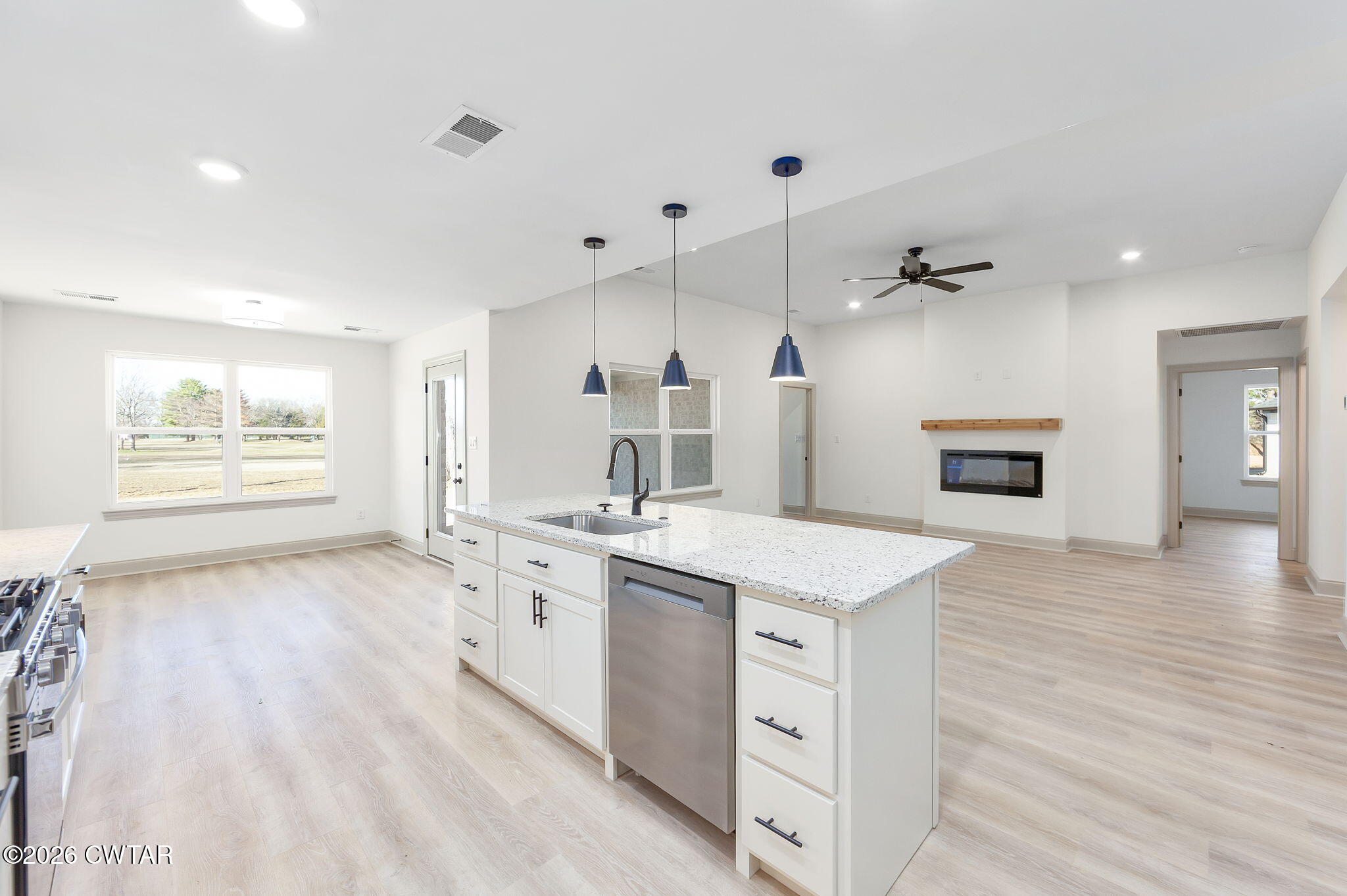 77 Grande Pnes Cove Jackson, TN 38305 - Photo 8 of 31 a large kitchen with a stove a sink dishwasher and a refrigerator with wooden floor