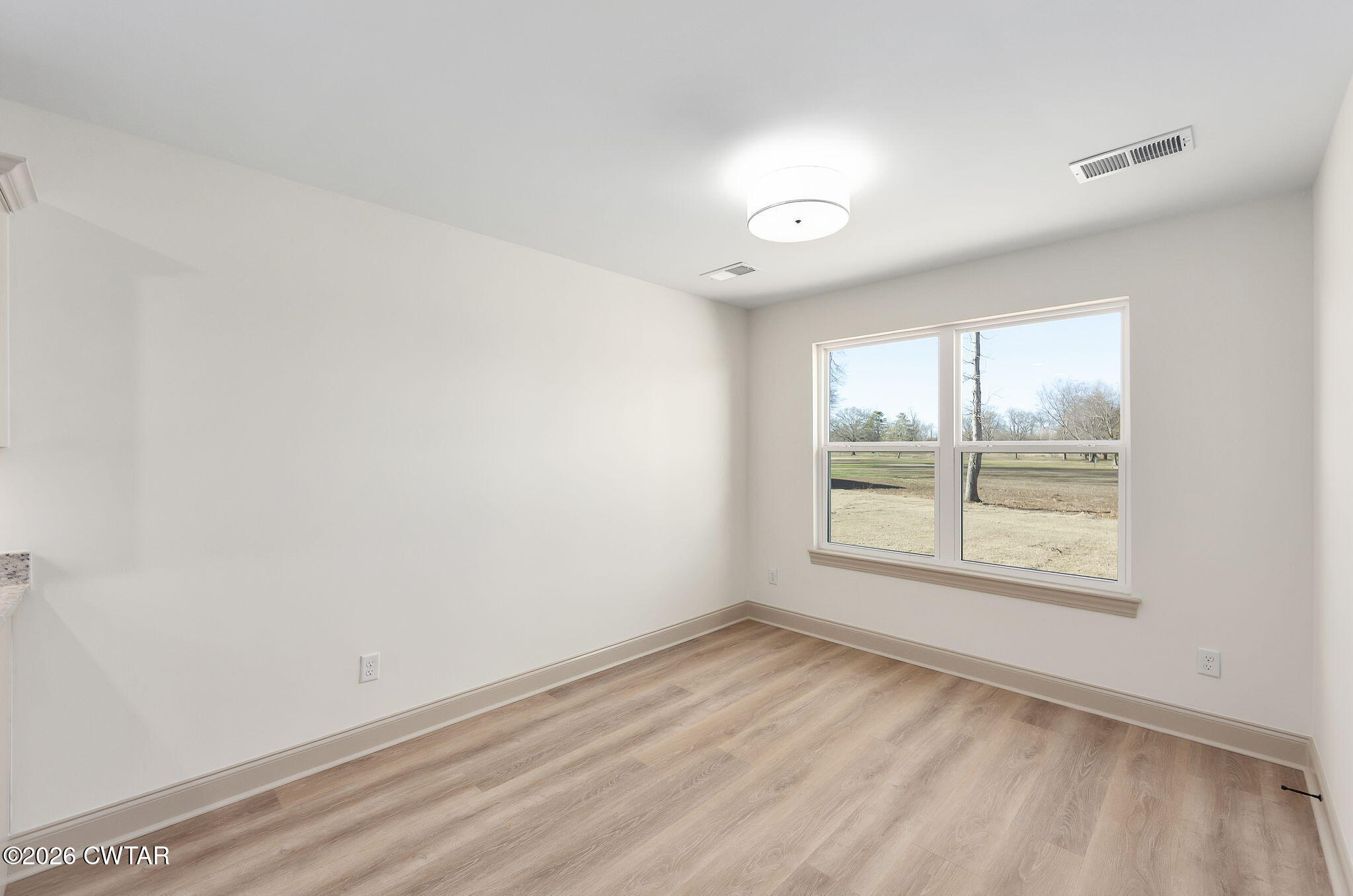 77 Grande Pnes Cove Jackson, TN 38305 - Photo 10 of 31 an empty room with wooden floor and windows