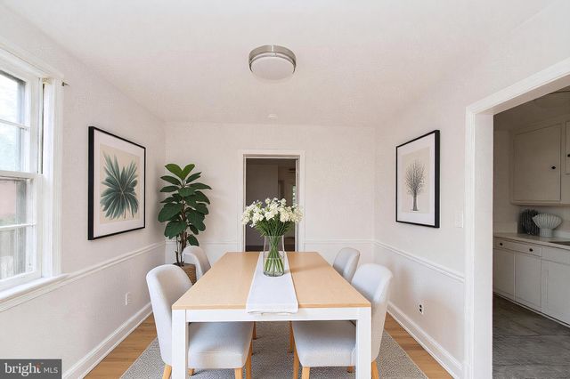 a view of a dining room with furniture and window