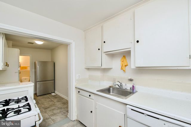 a kitchen with stainless steel appliances a sink a stove and a refrigerator