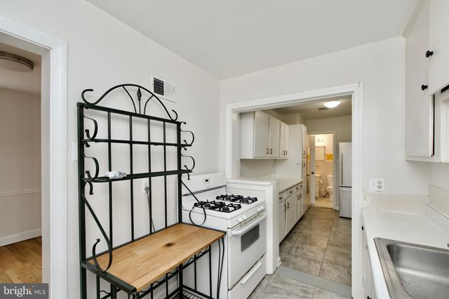 a kitchen with a refrigerator sink and cabinets