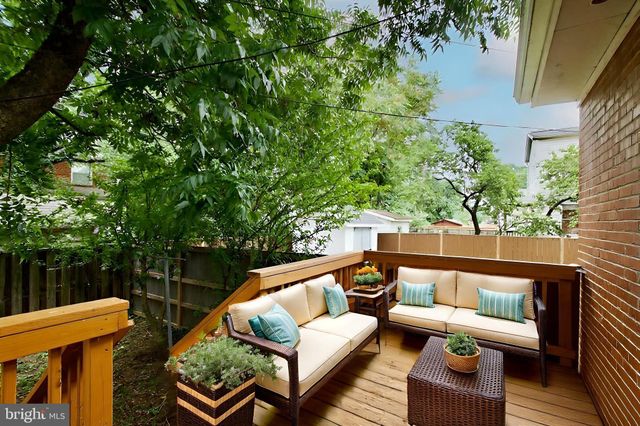a view of a house with a yard and wooden fence