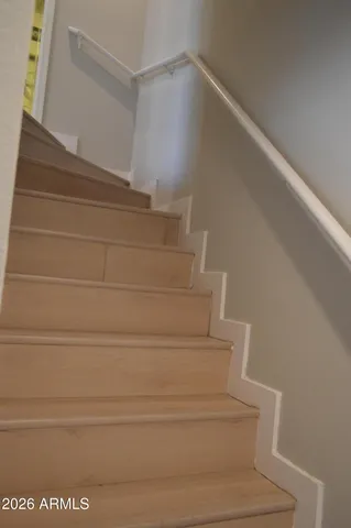 a living room with hard wood flooring and a rug