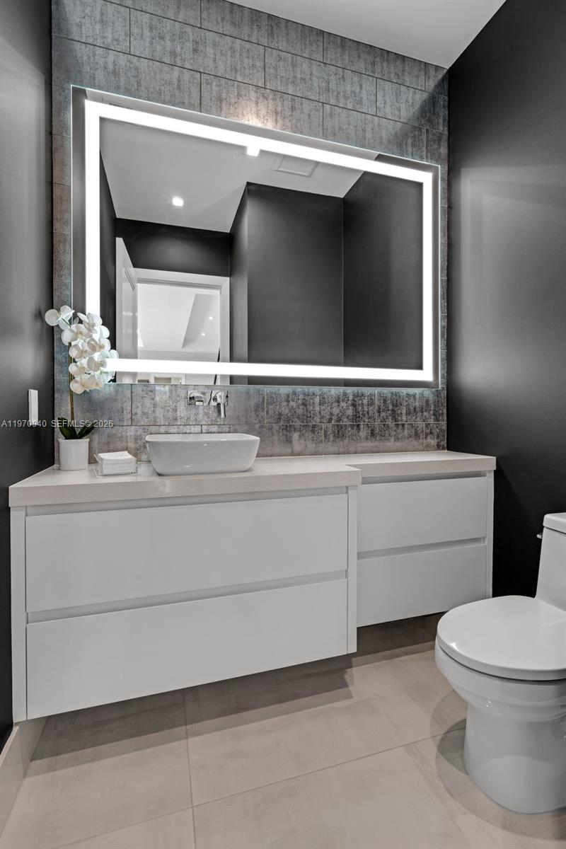 225 Northeast 3rd Street Boca Raton, FL 33432 - Photo 15 of 36 a bathroom with a sink toilet and mirror