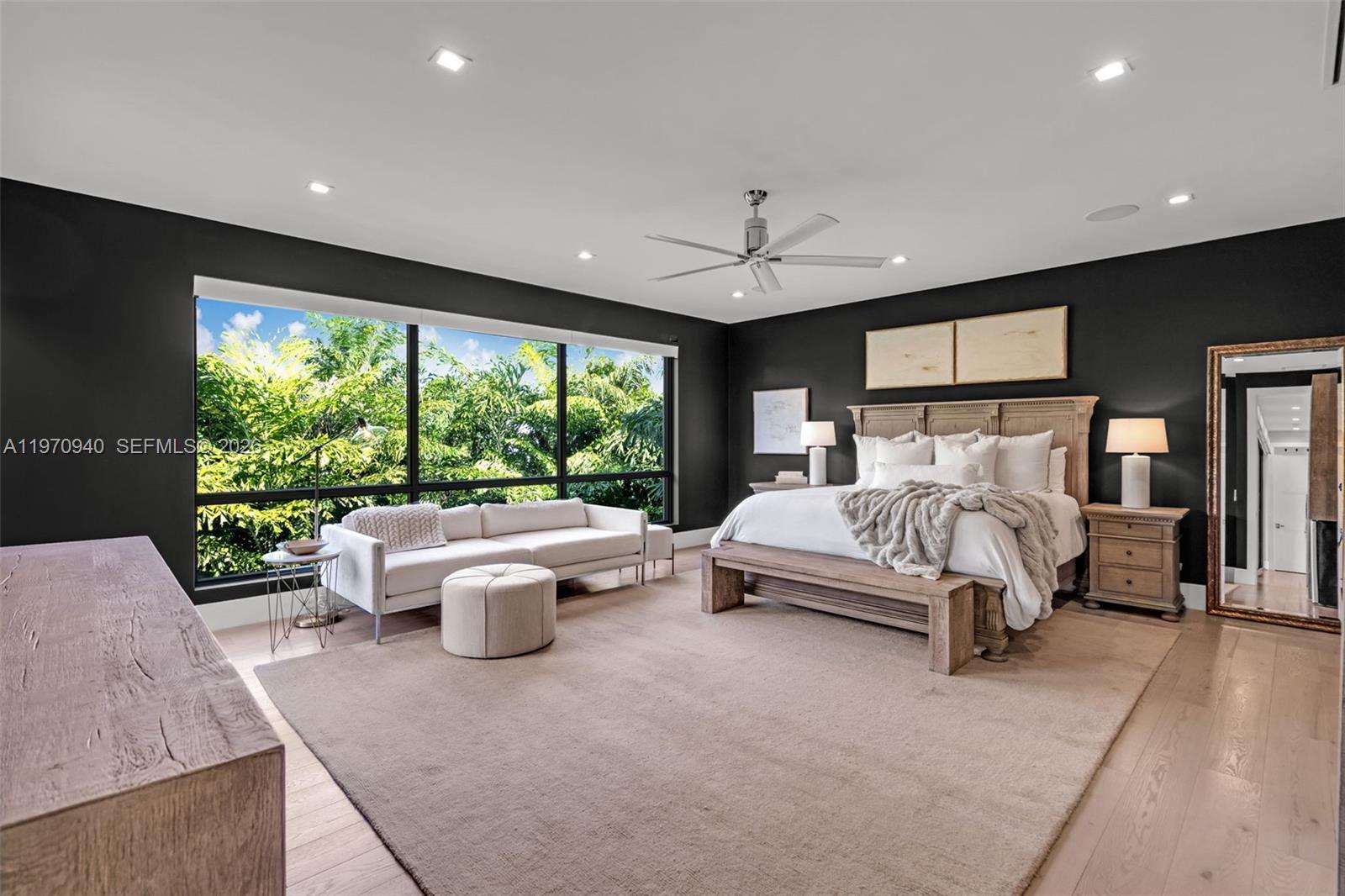 225 Northeast 3rd Street Boca Raton, FL 33432 - Photo 17 of 36 a spacious bedroom with a large bed and windows