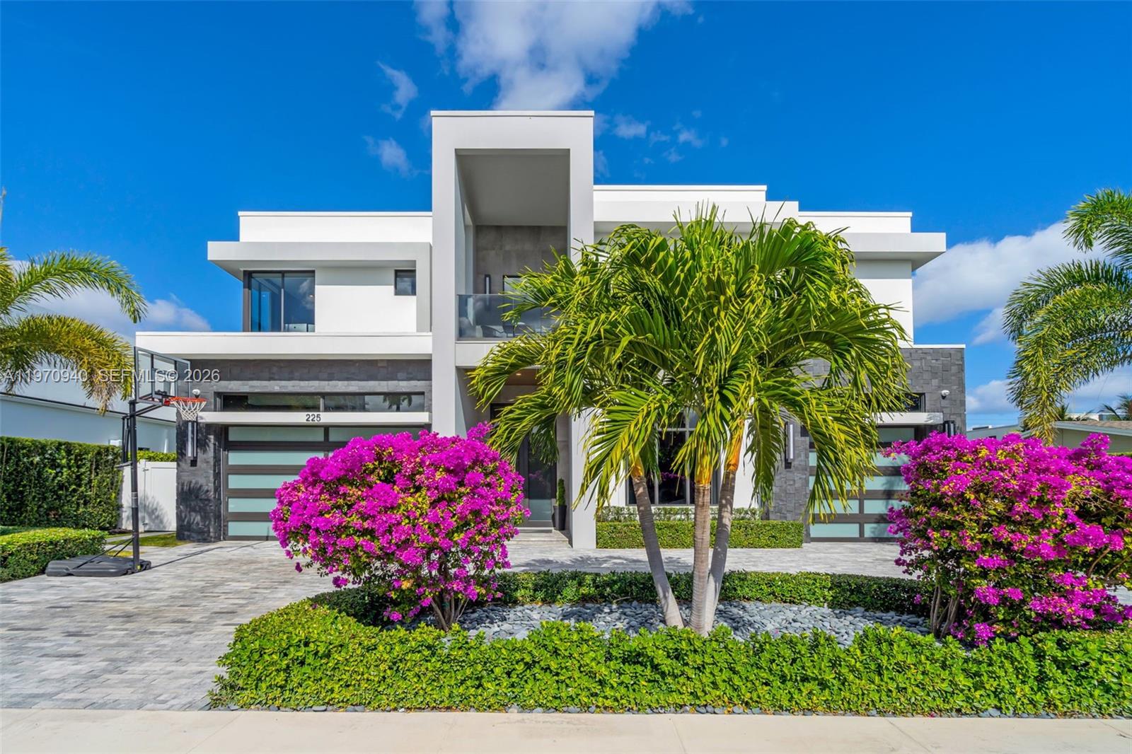 225 Northeast 3rd Street Boca Raton, FL 33432 - Photo 2 of 36 a front view of a house with a yard and fountain