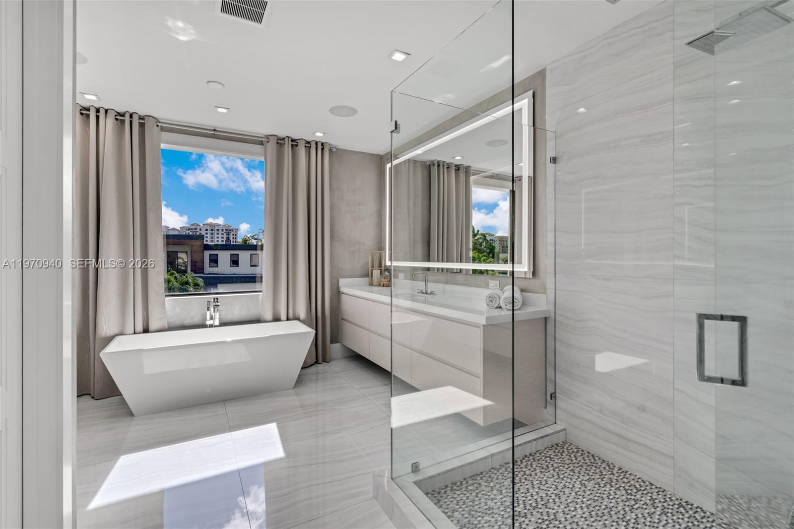 225 Northeast 3rd Street Boca Raton, FL 33432 - Photo 22 of 36 a bathroom with a sink toilet and shower