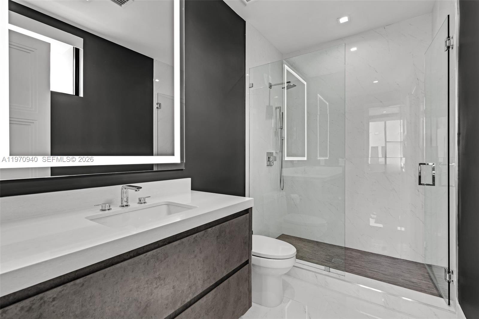 225 Northeast 3rd Street Boca Raton, FL 33432 - Photo 28 of 36 a bathroom with a sink a toilet and shower