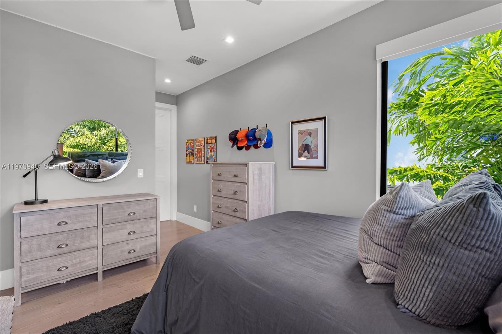 225 Northeast 3rd Street Boca Raton, FL 33432 - Photo 29 of 36 a bedroom with a bed and a dresser