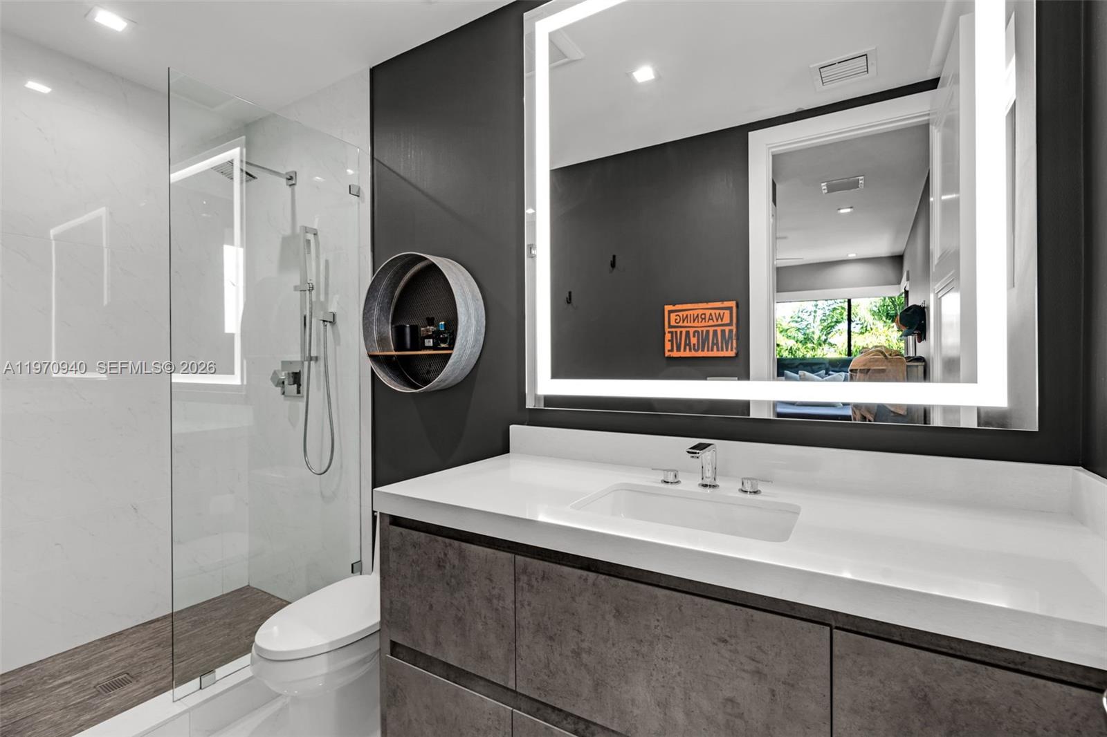 225 Northeast 3rd Street Boca Raton, FL 33432 - Photo 30 of 36 a bathroom with a sink and a mirror