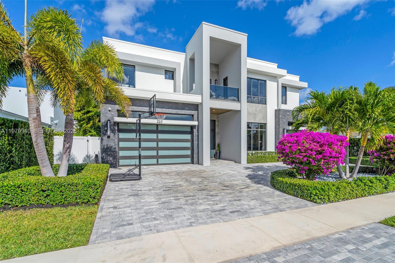 225 Northeast 3rd Street Boca Raton, FL 33432 - Photo 3 of 36 a front view of a house with a garden