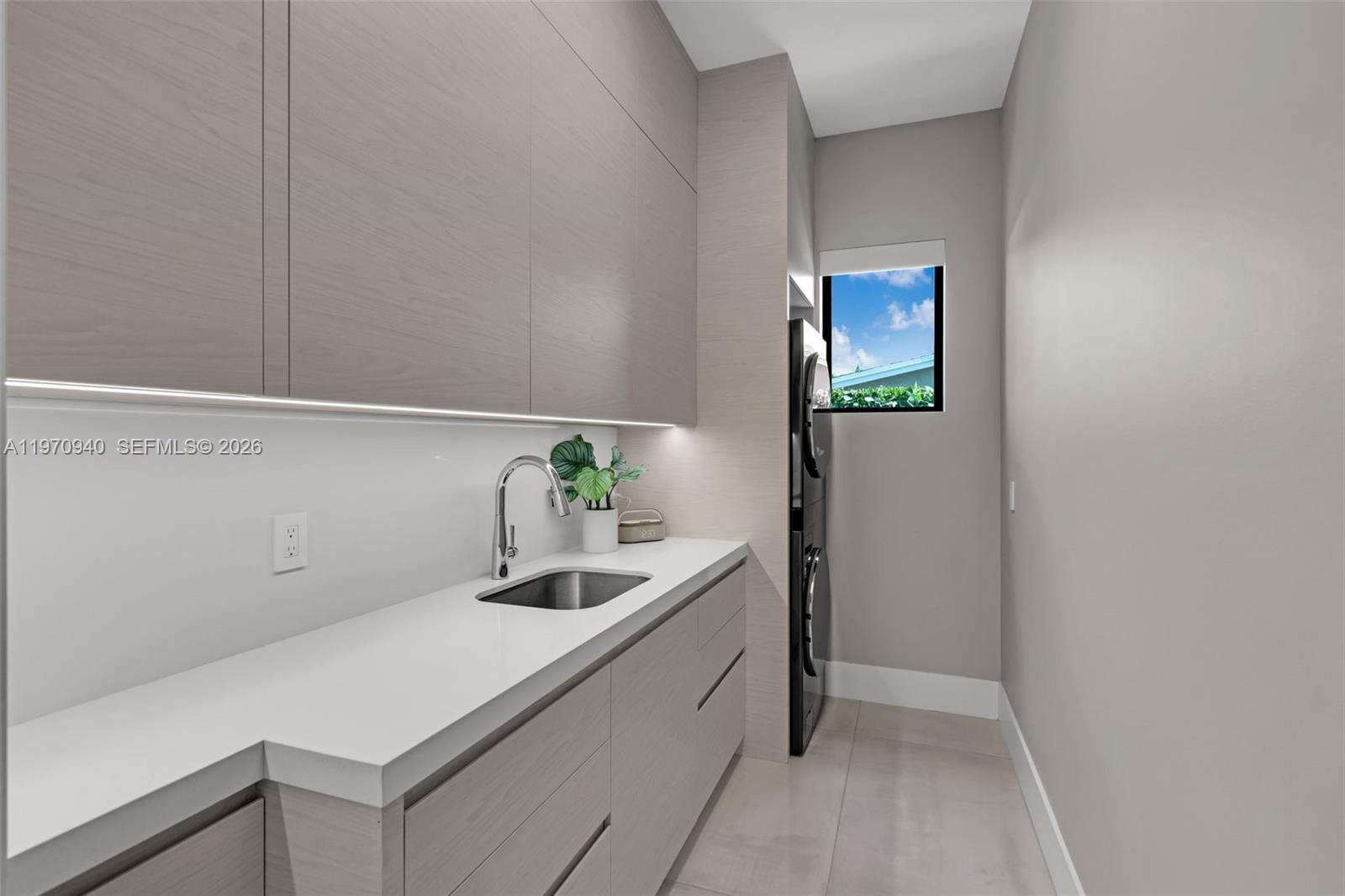 225 Northeast 3rd Street Boca Raton, FL 33432 - Photo 31 of 36 a kitchen with a sink and cabinets
