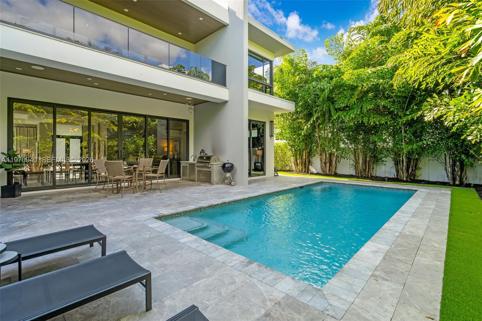 225 Northeast 3rd Street Boca Raton, FL 33432 - Photo 34 of 36 a view of a patio with swimming pool table and chairs