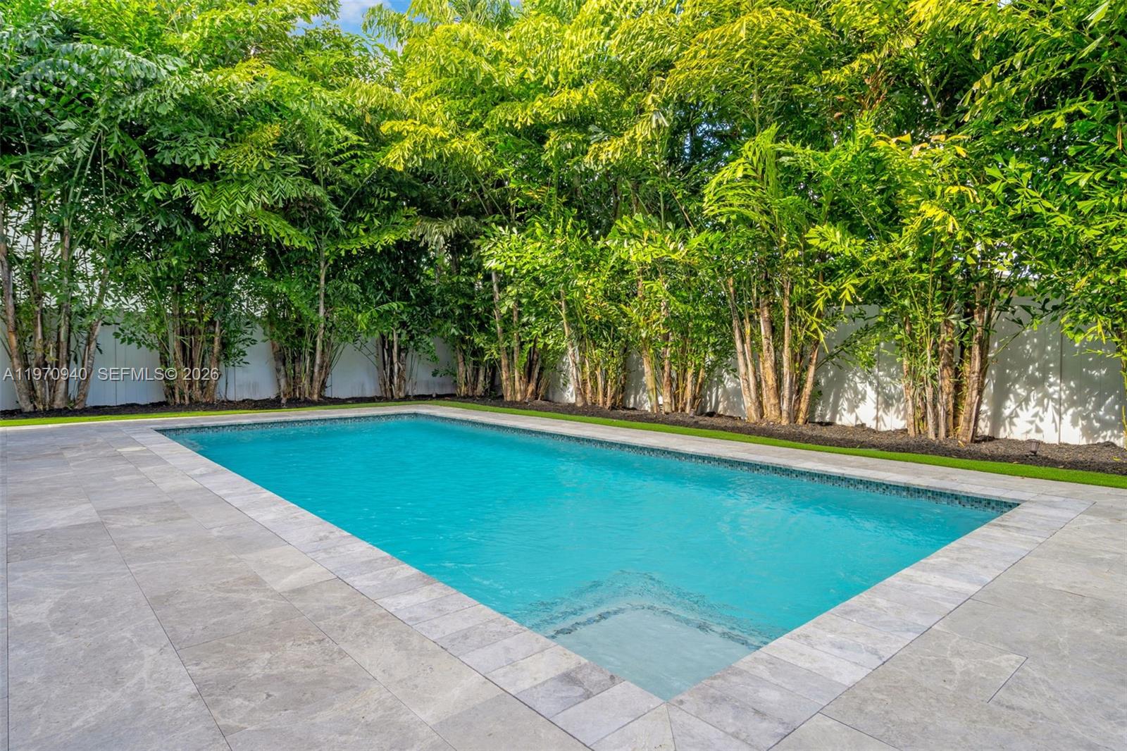 225 Northeast 3rd Street Boca Raton, FL 33432 - Photo 35 of 36 a view of swimming pool with trees in the background