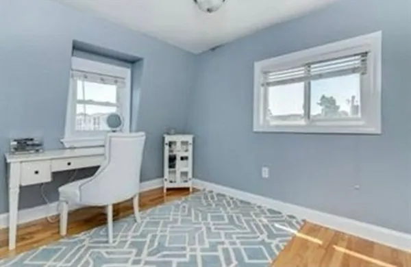 a workspace with wooden floor and a window