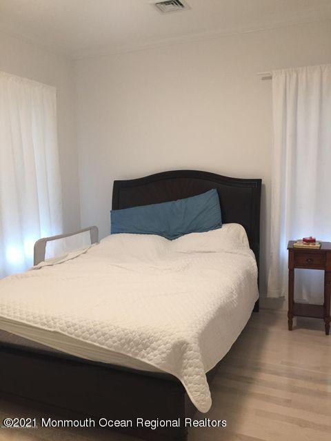 1066 Ocean Avenue, Unit 3 Sea Bright, NJ 07760 - Photo 12 of 12 a bedroom with a bed and a table