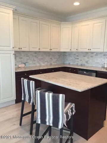a kitchen with a table chairs and cabinets