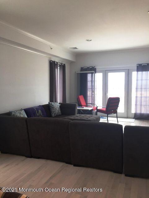 1066 Ocean Avenue, Unit 3 Sea Bright, NJ 07760 - Photo 4 of 12 a living room with furniture and a potted plant