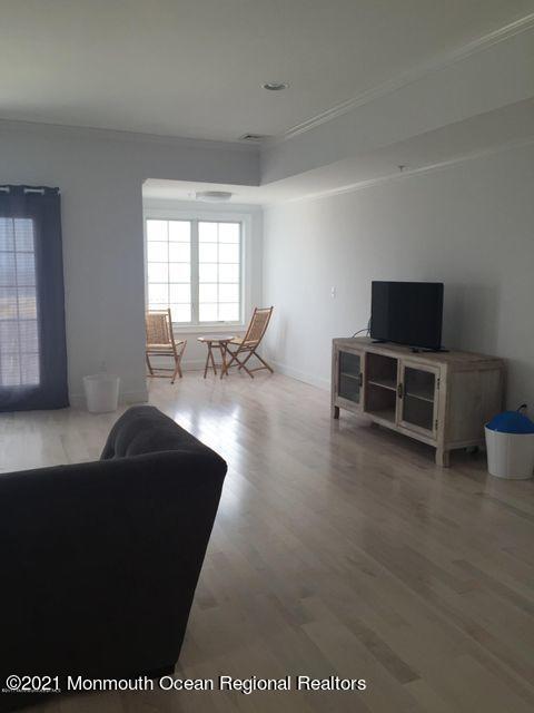 1066 Ocean Avenue, Unit 3 Sea Bright, NJ 07760 - Photo 5 of 12 a living room with furniture and a flat screen tv