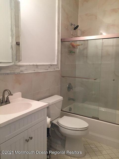 1066 Ocean Avenue, Unit 3 Sea Bright, NJ 07760 - Photo 7 of 12 a bathroom with a sink a toilet and shower