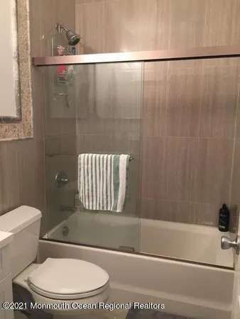 a bathroom with a sink a toilet and mirror