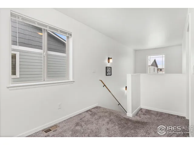 a living room with a bed furniture and a window