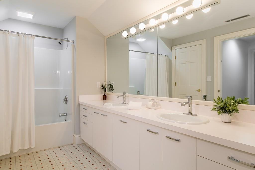 4 Garland Road Lincoln, MA 01773 - Photo 20 of 31 a bathroom with a sink double vanity and shower