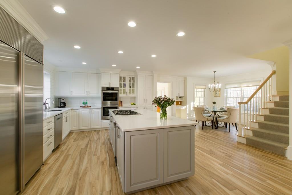 4 Garland Road Lincoln, MA 01773 - Photo 3 of 31 a kitchen with white cabinets and stainless steel appliances