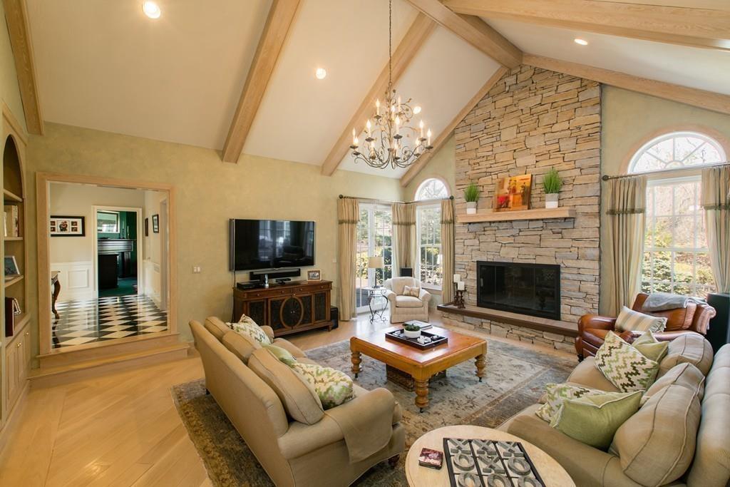 4 Garland Road Lincoln, MA 01773 - Photo 7 of 31 a living room with furniture a flat screen tv and a fireplace