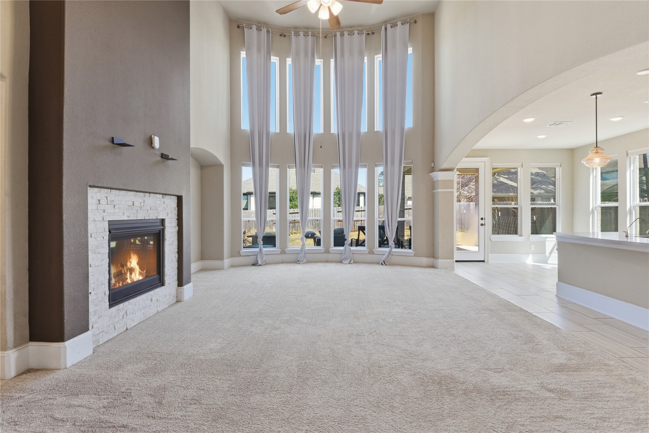 17501 Spice Merlot Lane Conroe, TX 77302 - Photo 13 of 50 a view of an empty room with a fireplace and large window