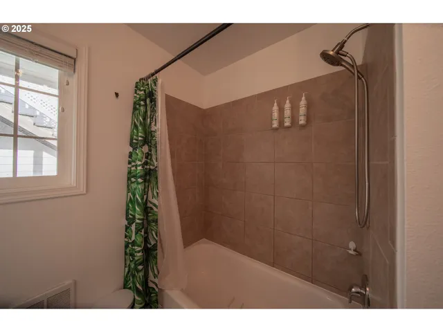 a bathroom with a shower and a shower