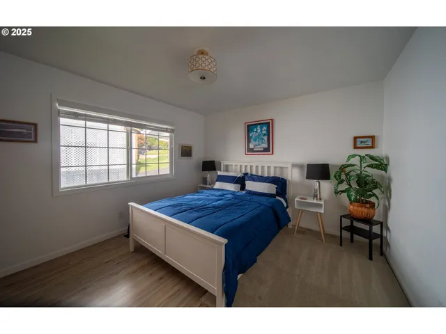 a spacious bedroom with a bed and a window