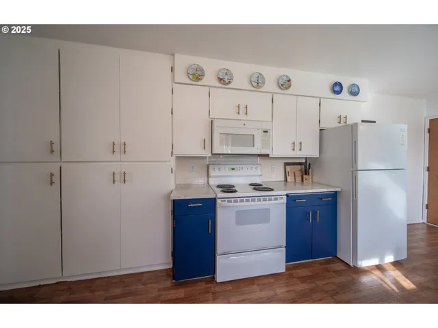 a kitchen with stainless steel appliances granite countertop a refrigerator and a stove