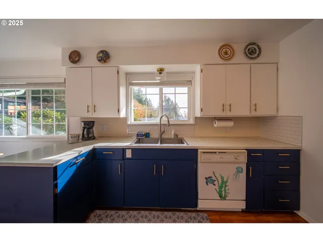 a kitchen with a sink cabinets and window