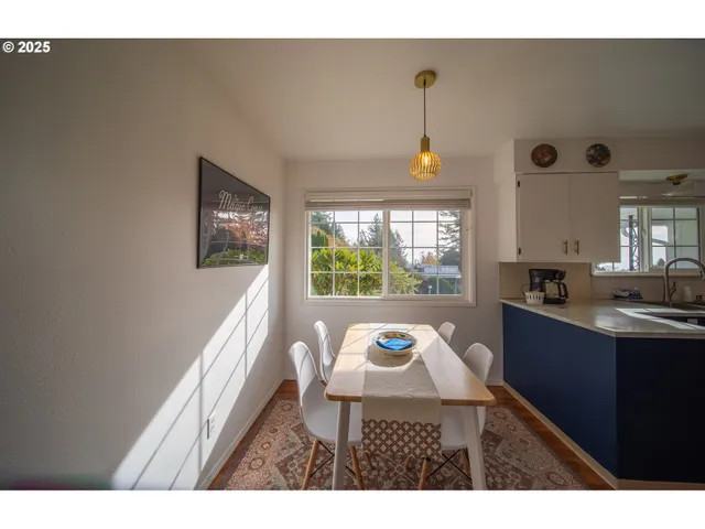 a living room with a window and a table