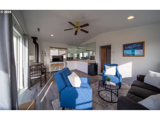 a living room with furniture and kitchen view