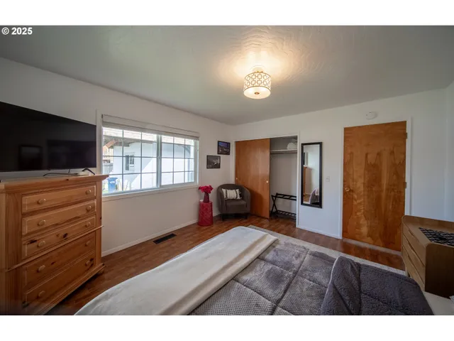 a bedroom with furniture and flat screen tv