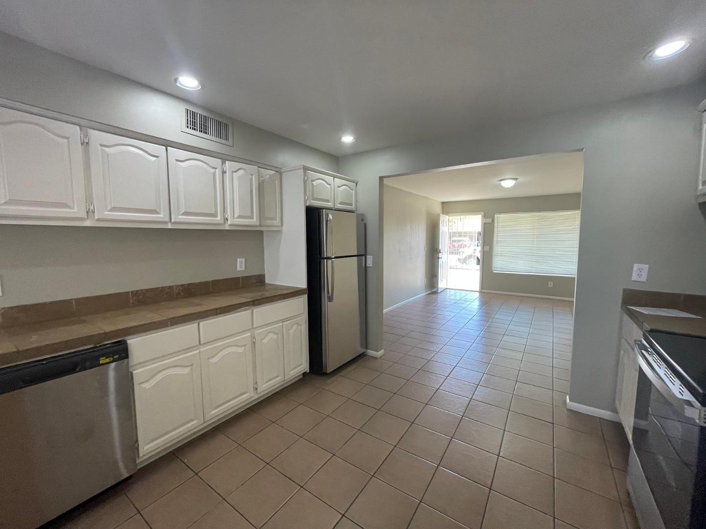 10902 West Montecito Avenue Phoenix, AZ 85037 - Photo 6 of 22 a kitchen with stainless steel appliances granite countertop a refrigerator and a sink
