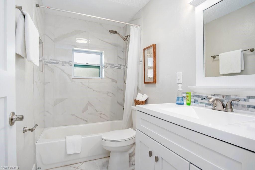 1207 Hernando Street Naples, FL 34103 - Photo 25 of 37 a bathroom with a sink a toilet and shower