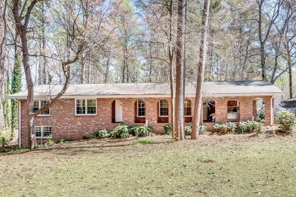 61 Patillo Road Stockbridge, GA 30281 - Photo 1 of 1 a front view of house with yard and trees around