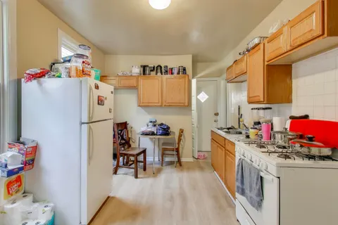 a kitchen with refrigerator and cabinets