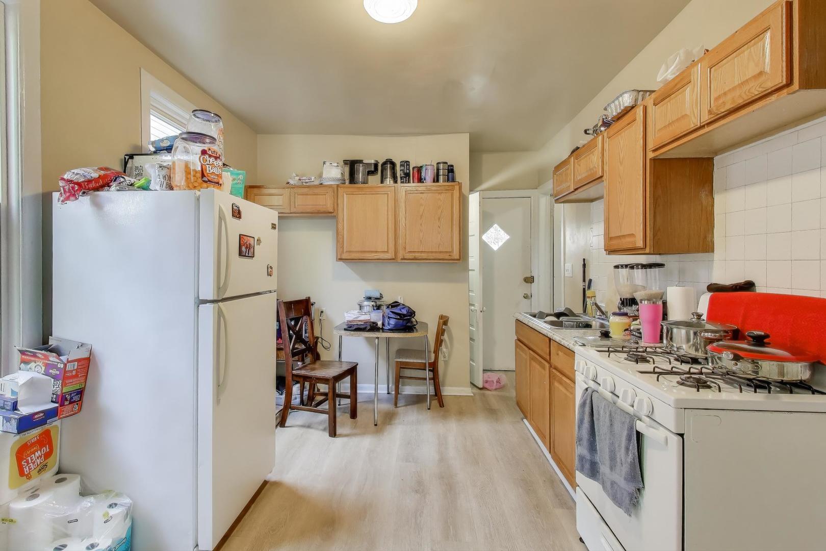 4322 North Monticello Avenue Chicago, IL 60618 - Photo 14 of 37 a kitchen with refrigerator and cabinets