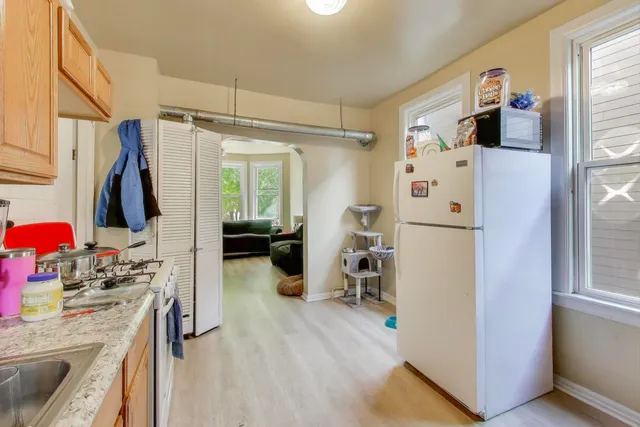 a kitchen with a refrigerator and a stove