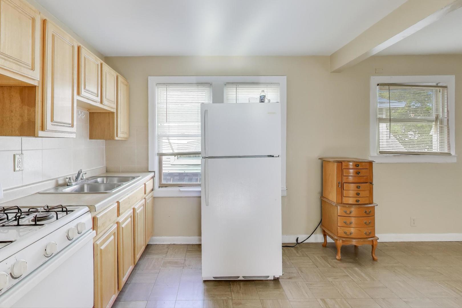 4322 North Monticello Avenue Chicago, IL 60618 - Photo 24 of 37 a kitchen with a refrigerator a stove a sink and a window