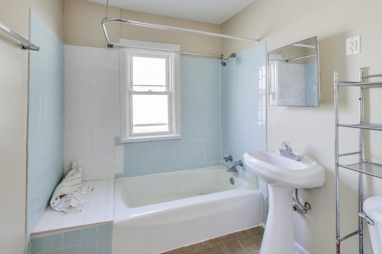 4322 North Monticello Avenue Chicago, IL 60618 - Photo 28 of 37 a bathroom with a sink a bathtub and a shower