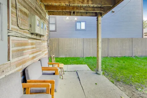 a backyard of a house with outdoor seating