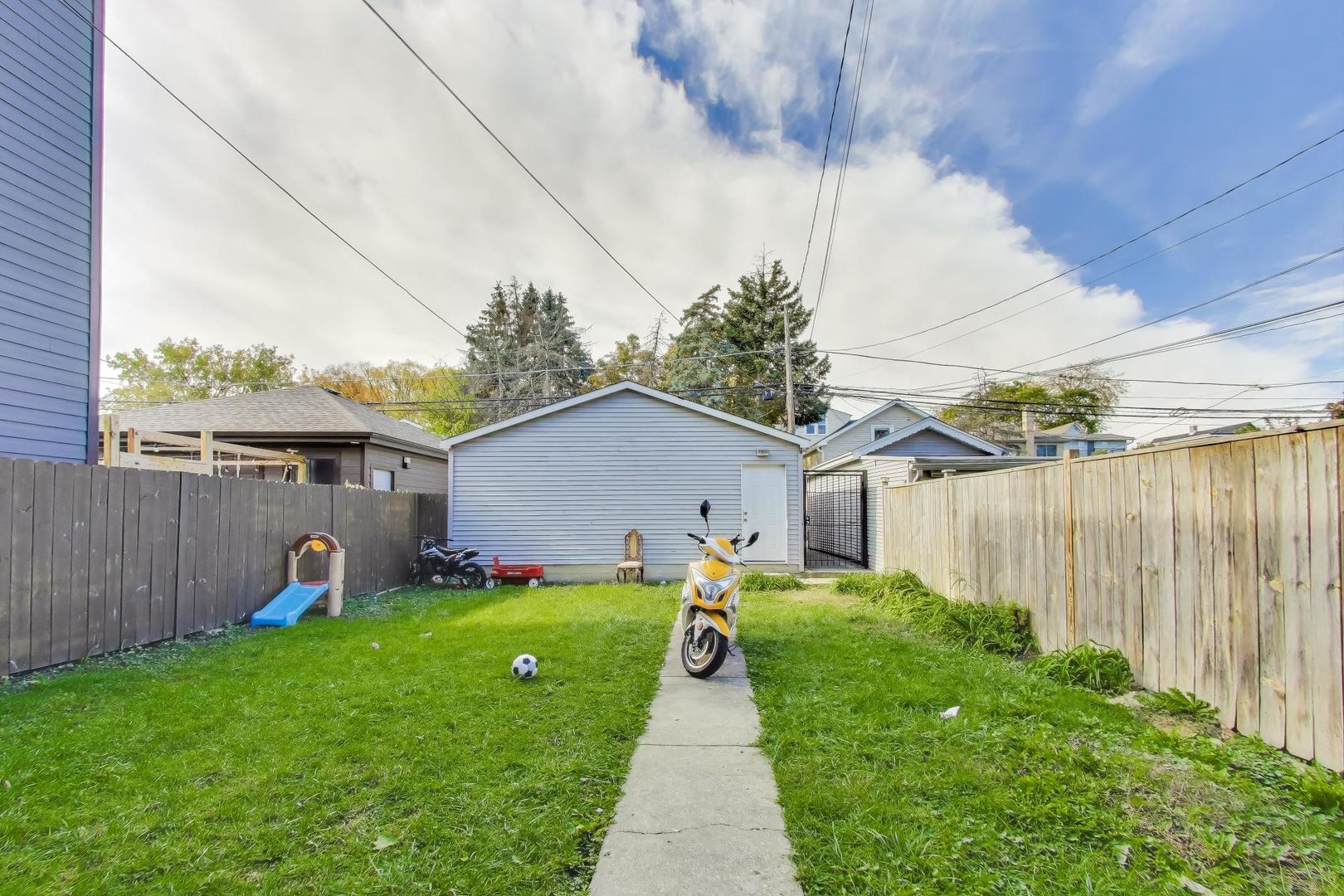 4322 North Monticello Avenue Chicago, IL 60618 - Photo 32 of 37 a front view of a house with garden and a fence
