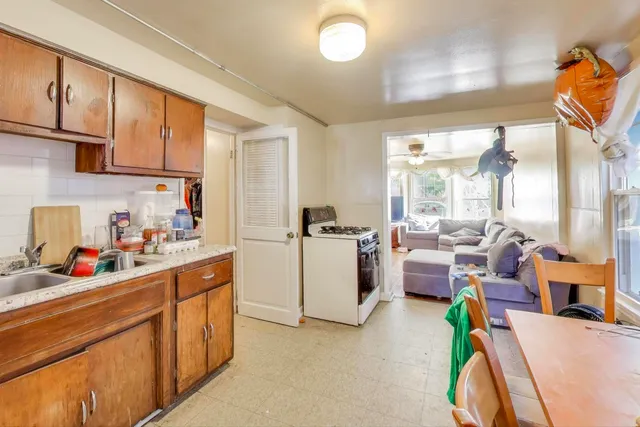 a kitchen that has a lot of cabinets and appliances