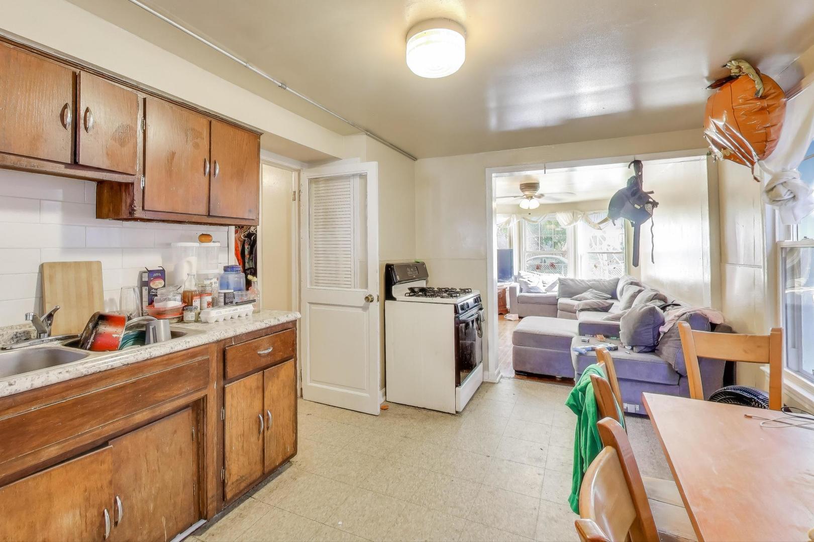 4322 North Monticello Avenue Chicago, IL 60618 - Photo 6 of 37 a kitchen that has a lot of cabinets and appliances